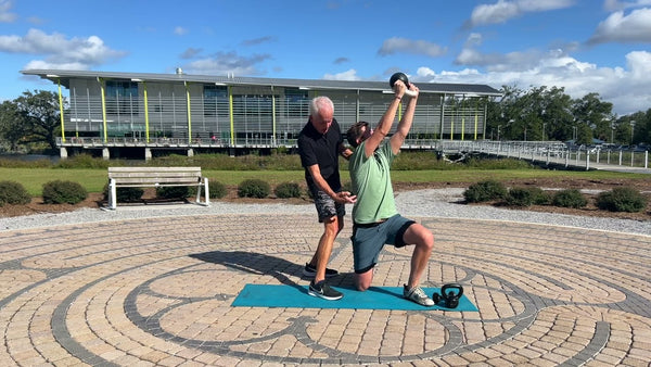 Kneeling Kettlebell Chop and Lift with Bicep Curl to Overhead Press