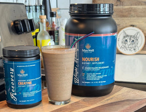 A tall glass of chocolate recovery shake framed by MaxWell Creatine and MaxWell Nourish